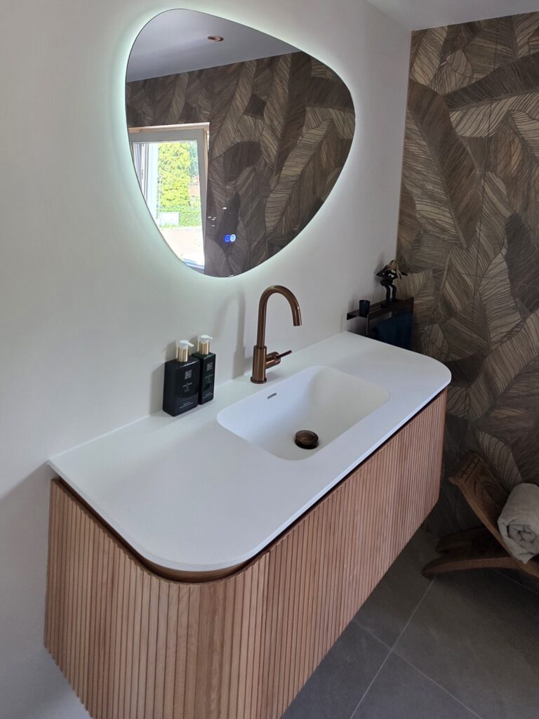 Luxe badkamer met houten meubel en decoratieve tegelwand